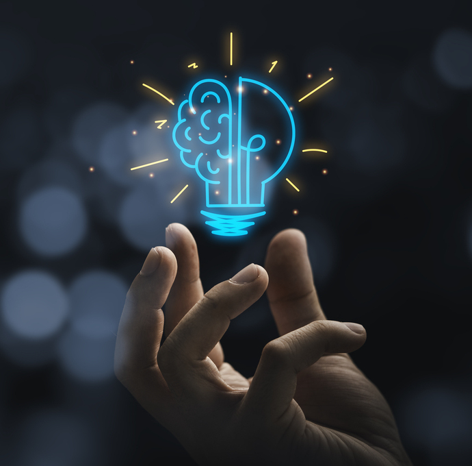 Hand holding drawing virtual lightbulb with brain on bokeh background for creative and smart thinking idea concep